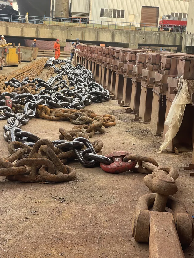 Anchor chains and shackles ranged by the keel blocks. Shanghai, February 2025.