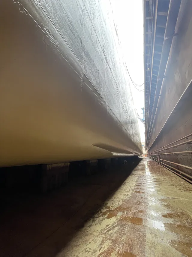 Painted flat bottom on keel blocks, looking along the dock. Shanghai, February 2025.
