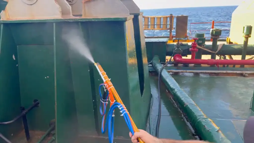 Home-built spray lance applying cleaner from the deck